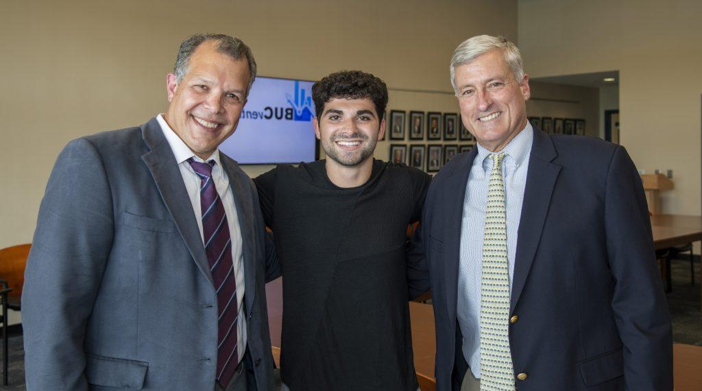 Justin Rudolph '19, an alumnus of this private school, a proud graduate and inaugural BUC Ventures winner, smiling with Headmaster Joseph Seivold and Carlo DiNota